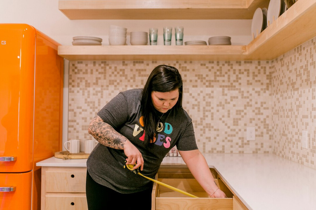 woman organizing closet shelves